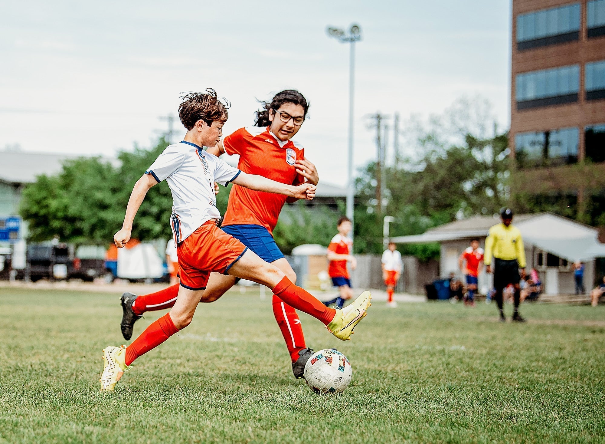 Youth soccer match with two players competing for the ball
