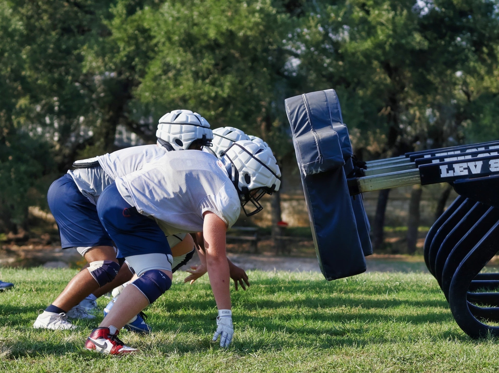 Youth football team in spring training wearing Guardian Caps