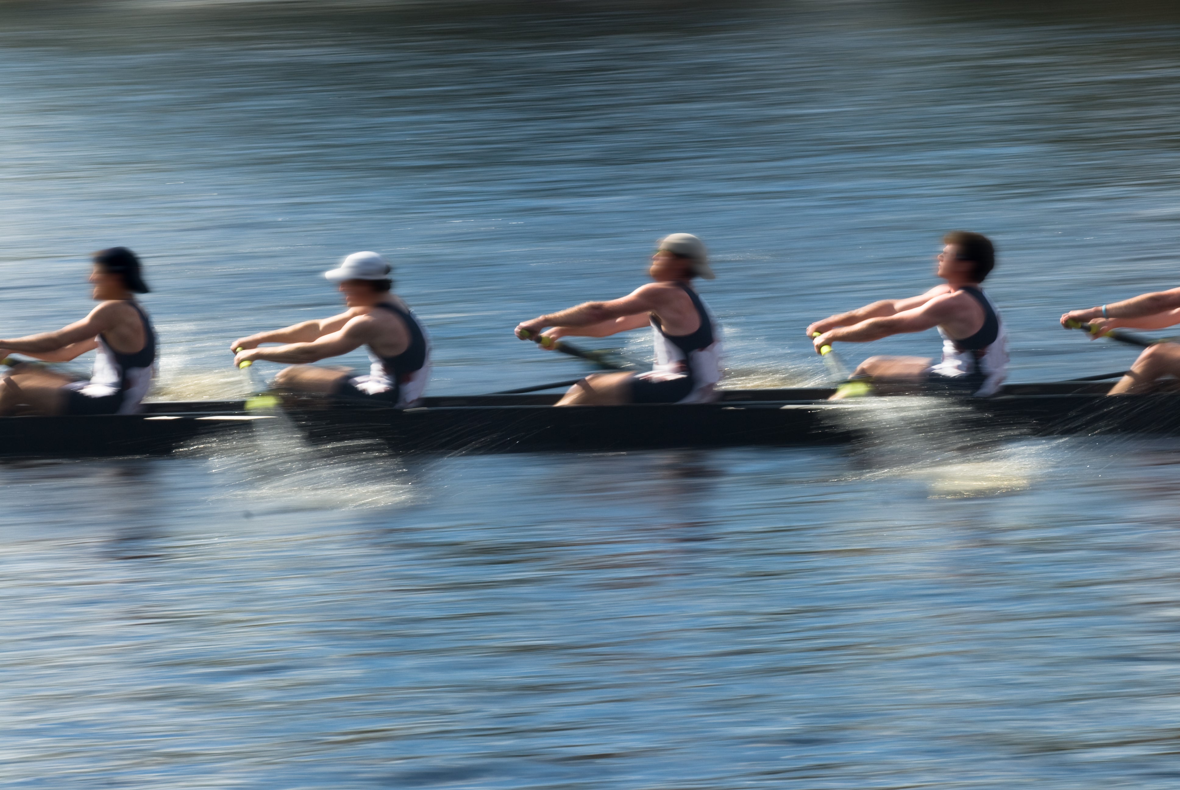 Rowing team rowing in a river during the summer