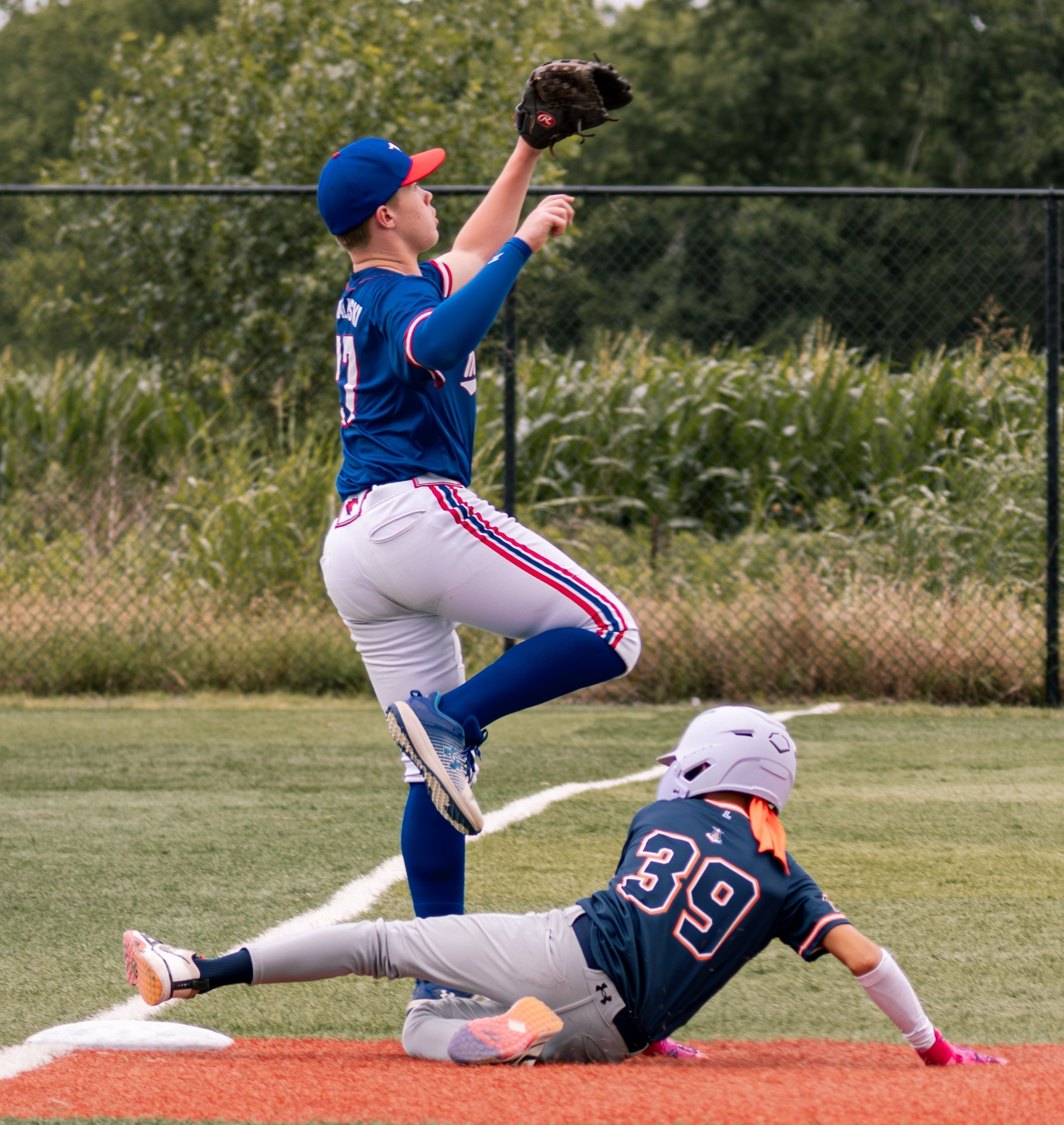 Youth baseball players in a summer baseball game