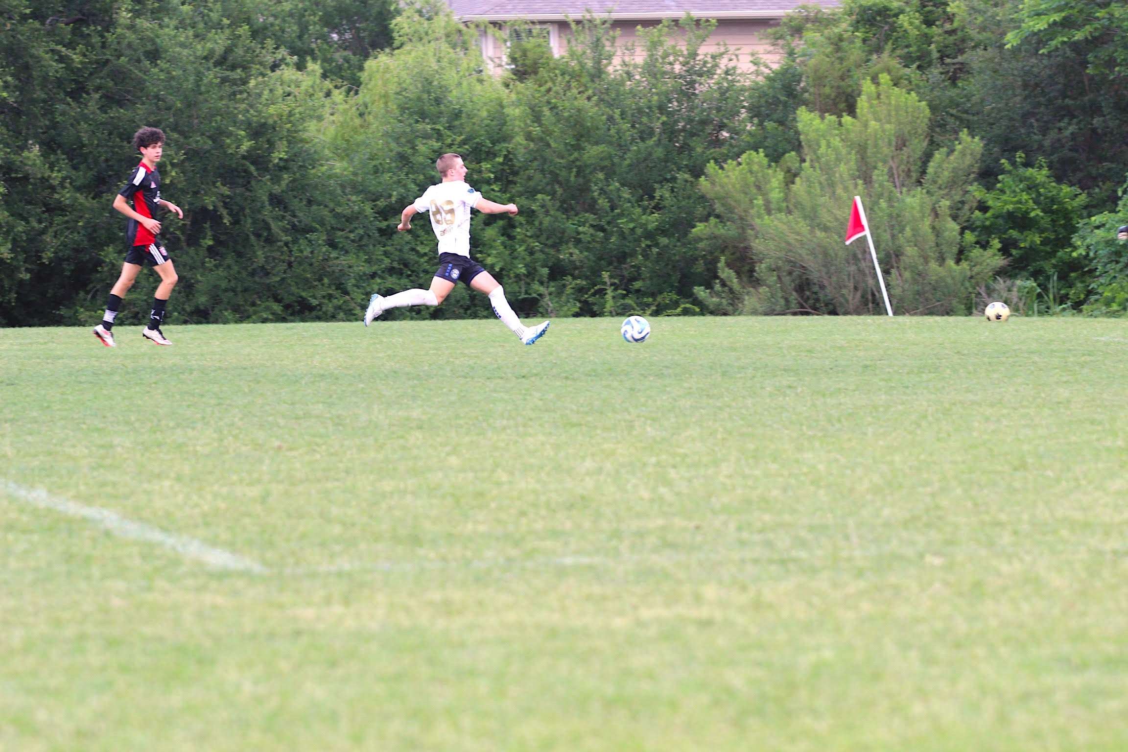 High school soccer players training outdoors in heat with cooling breaks