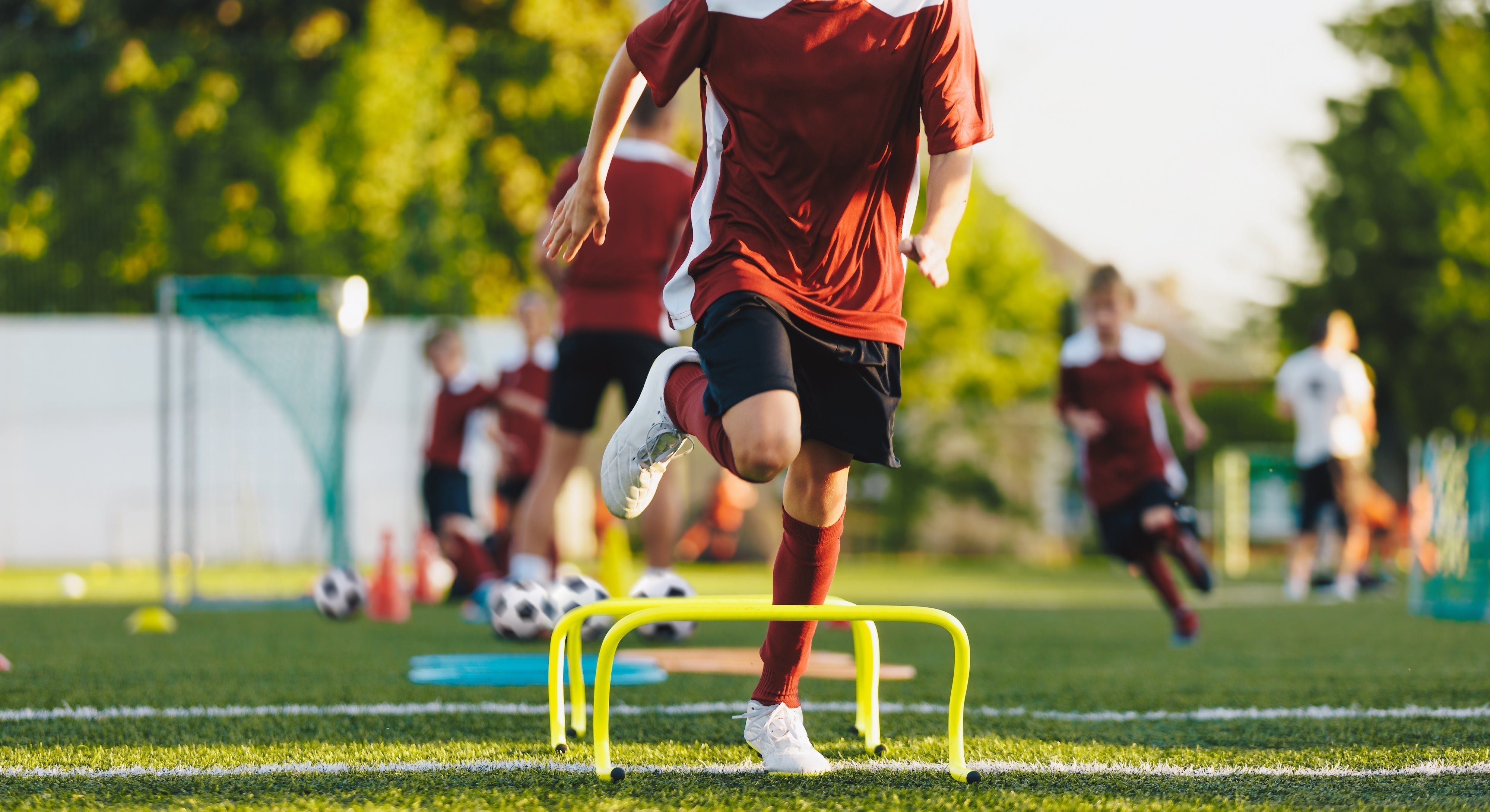 Youth soccer play doing drills in the summer heat