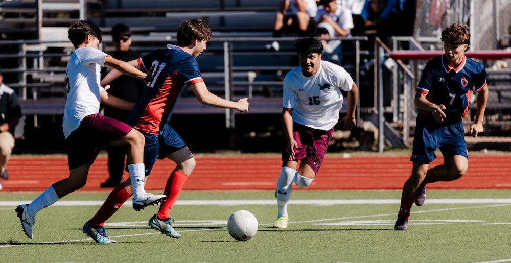 Boys soccer game outdoors in heat showing individual athlete differences