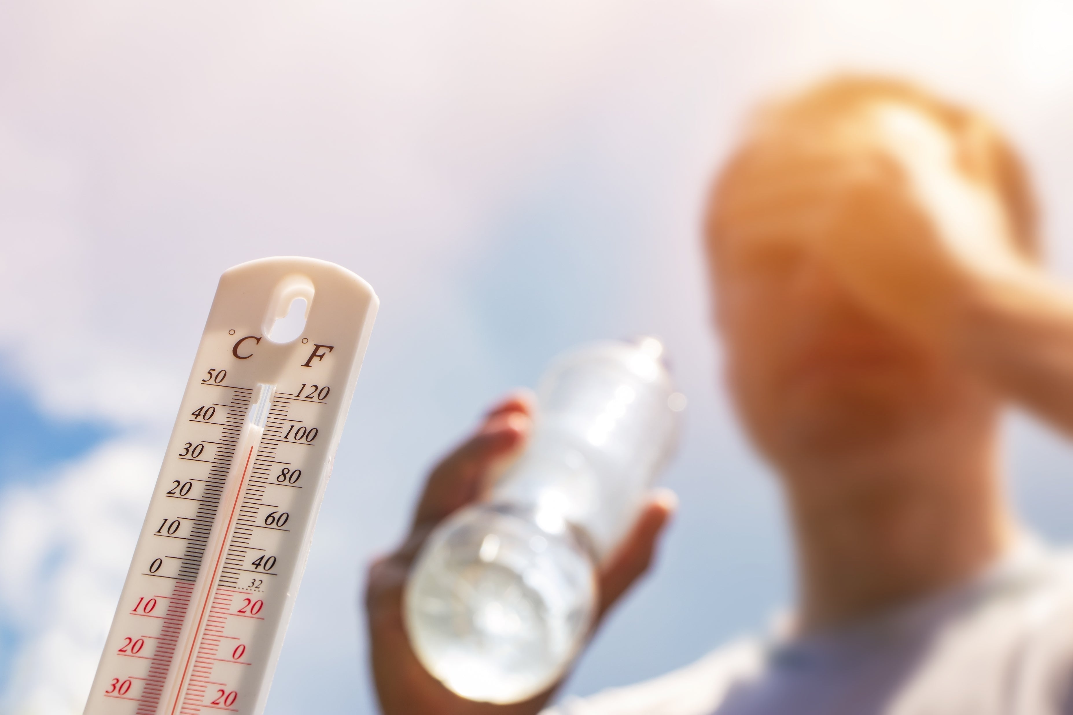 Athlete drinking water and temperature sensor detecting outdoor temps