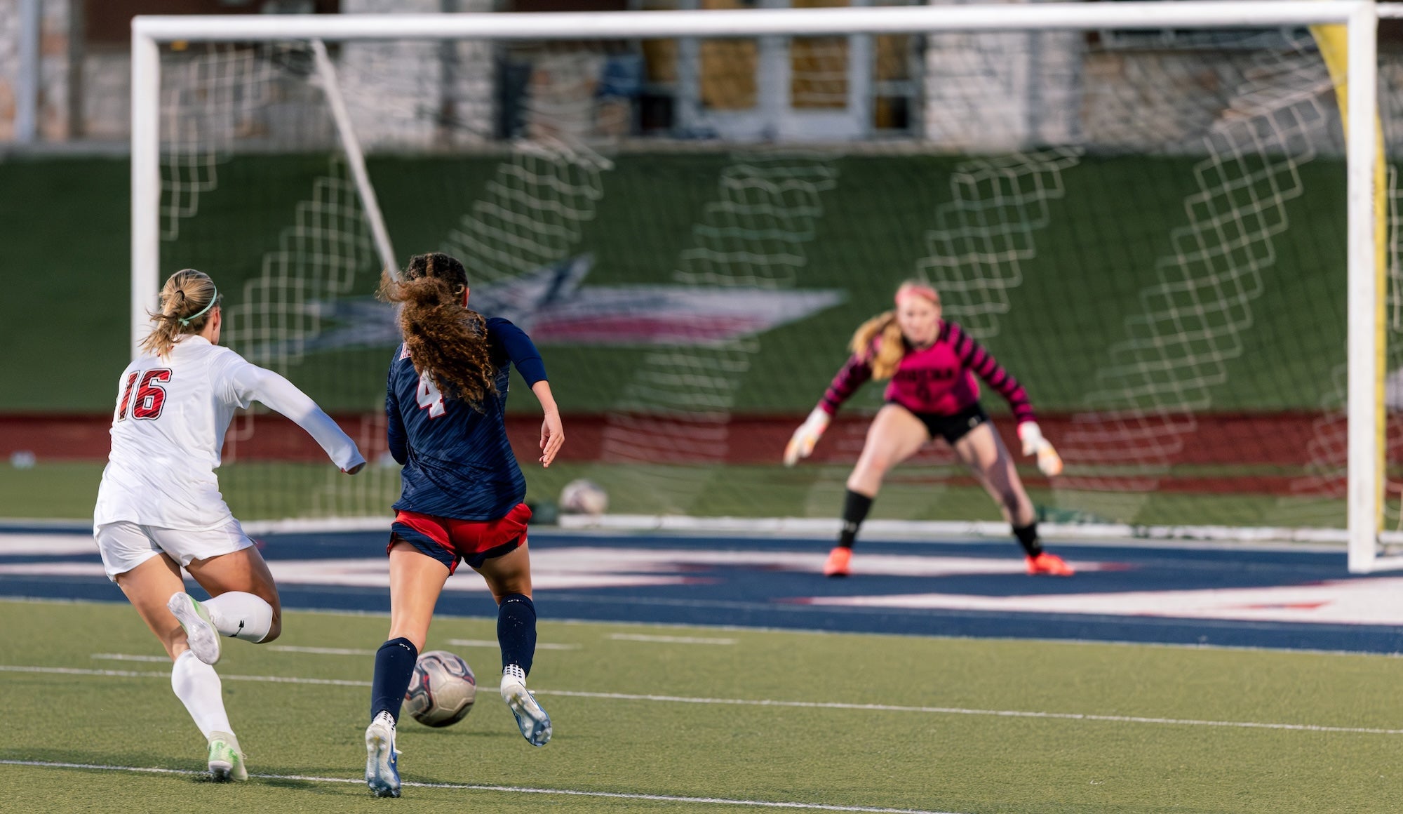 Girls varsity soccer player in action during outdoor heat conditions