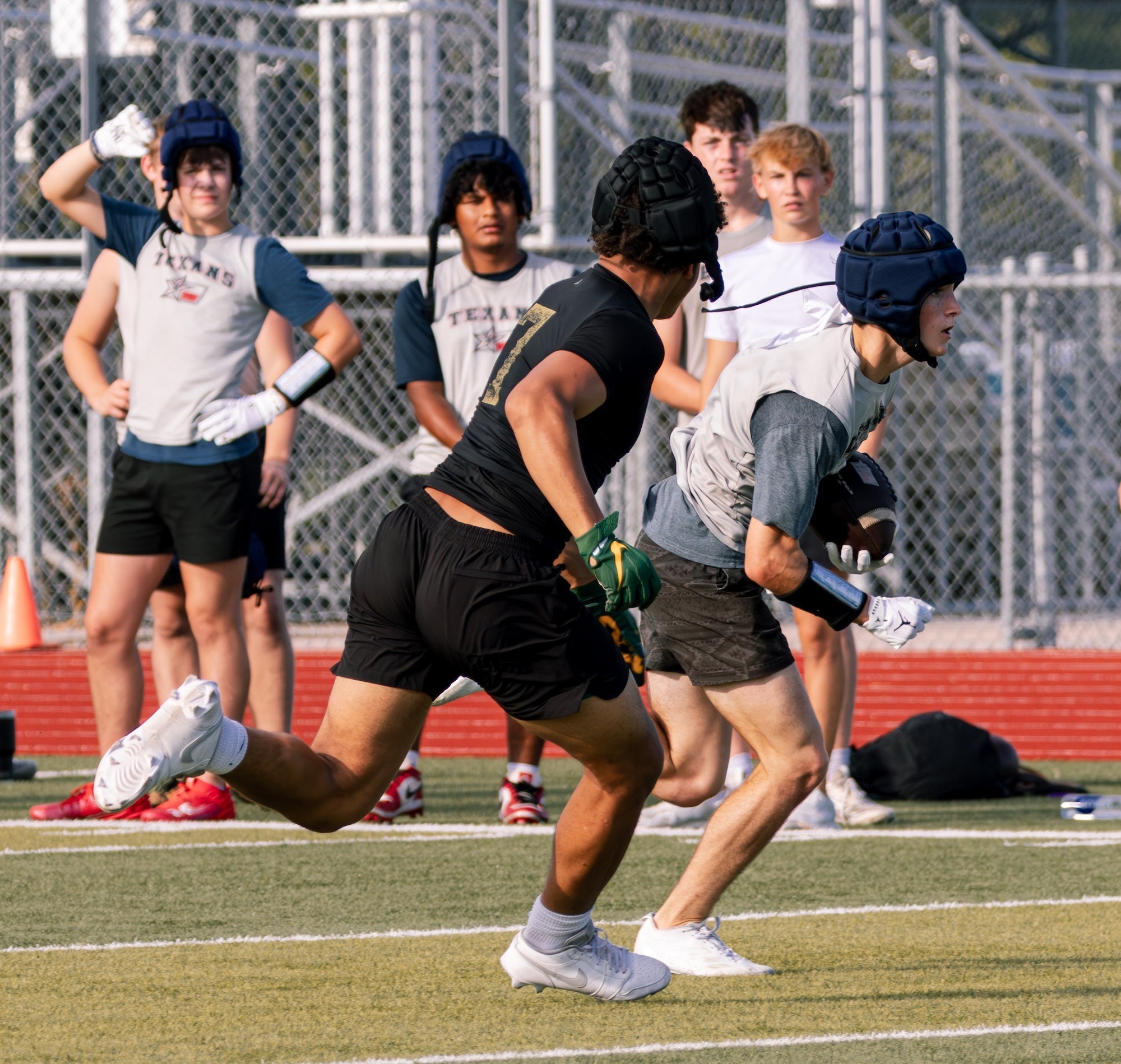 Summer 7-on-7 football offense training in heat conditions
